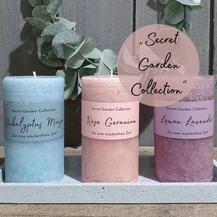 Drei Schulthess Duftkerzen aus der Secret Garden Collection in den Sorten Eukalyptus Minze, Rose Geranium und Lemon Lavender, dekorativ arrangiert mit Eukalyptuszweigen – natürliche Düfte für eine mückenfreie, entspannte Atmosphäre.