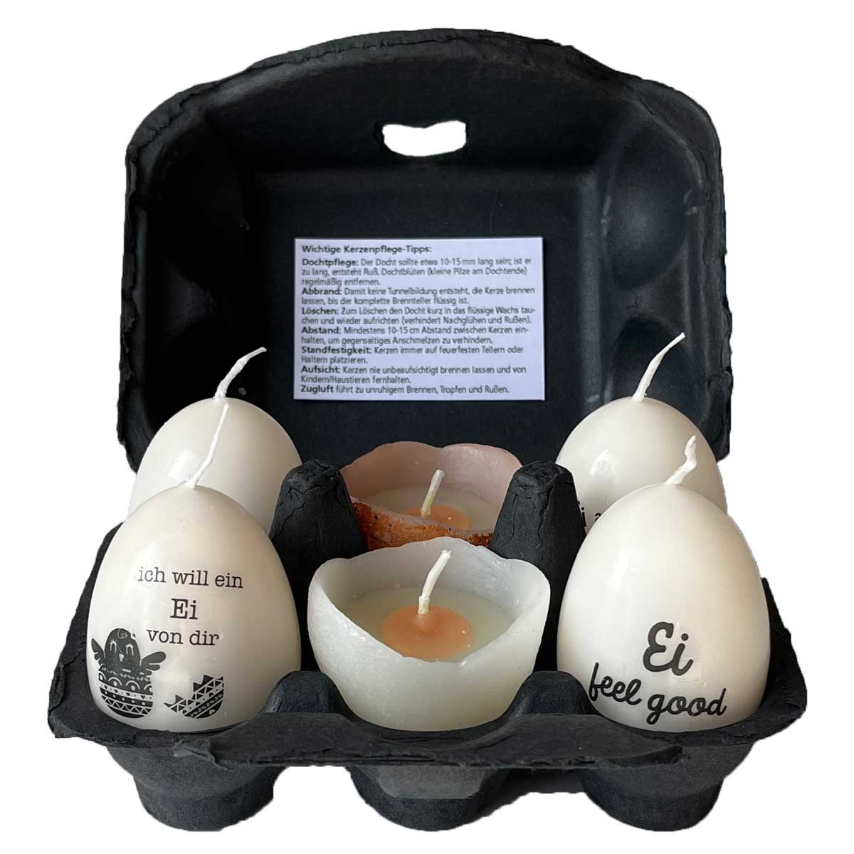Ostereierkerzen schwarz weiß im 6er Set im geöffneten Eierkarton – dekorative Osterkerzen mit Schriftmotiven und Ei-Teelicht als originelle Osterdeko oder Geschenkidee.