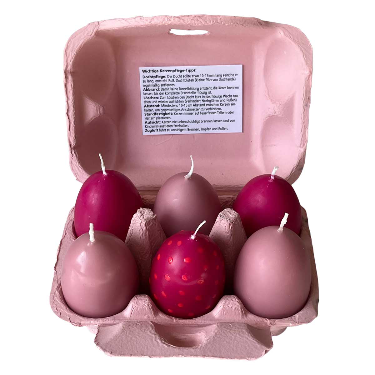 Ostereierkerzen rosé 6er Set im geöffneten Eierkarton – dekorative Kerzen in Ei-Form in Rosé- und Beerentönen als stilvolle Osterdekoration oder Geschenkidee.